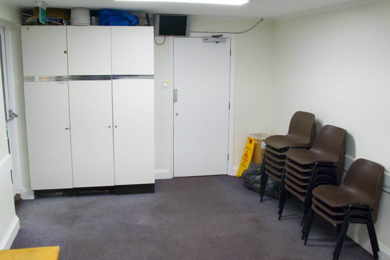 The Elliott meeting room, with storage cupboards and stacked chairs
